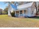 Charming cottage-style home with a metal roof and welcoming front porch at 6316 Rockland Rd, Lithonia, GA 30038