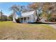 Quaint white home with metal roof, front porch and a detached garage at 6316 Rockland Rd, Lithonia, GA 30038