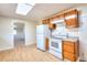 Kitchen with wood cabinets, white appliances, and hardwood floors at 6316 Rockland Rd, Lithonia, GA 30038