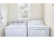 Bright laundry room includes a window, with a white washer and dryer at 6316 Rockland Rd, Lithonia, GA 30038