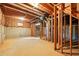 Spacious unfinished basement with exposed beams, cement foundation, and space for customization at 1256 Spring Park Sw Dr, Atlanta, GA 30311