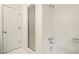 This bathroom has a combo shower and tub with a white tiled shower and a glass shower door at 1256 Spring Park Sw Dr, Atlanta, GA 30311