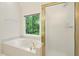 Bright bathroom with soaking tub, separate shower, and natural light at 1256 Spring Park Sw Dr, Atlanta, GA 30311