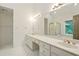 Bathroom with large vanity, double sinks, large mirror, and updated tiling at 1256 Spring Park Sw Dr, Atlanta, GA 30311