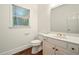 Bathroom featuring a vanity, toilet, a window letting in natural light, and wooden flooring at 1256 Spring Park Sw Dr, Atlanta, GA 30311