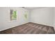 This bedroom offers soft carpeting and two windows overlooking the outdoors at 1256 Spring Park Sw Dr, Atlanta, GA 30311