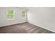 This bedroom features neutral-colored walls, carpeting, and two windows at 1256 Spring Park Sw Dr, Atlanta, GA 30311