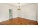 Formal dining room featuring hardwood floors, elegant wainscoting, and a stylish chandelier at 1256 Spring Park Sw Dr, Atlanta, GA 30311