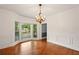 Bright dining room showcasing hardwood floors, wainscoting, a chandelier, and a bay window at 1256 Spring Park Sw Dr, Atlanta, GA 30311