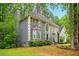 Attractive home with a dark grey exterior, manicured shrubs, and mature trees surrounding the property at 1256 Spring Park Sw Dr, Atlanta, GA 30311