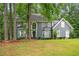 Charming two-story home featuring a well-manicured lawn, mature trees, and a classic facade at 1256 Spring Park Sw Dr, Atlanta, GA 30311