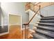 Inviting foyer featuring a staircase with carpeted steps and hardwood floors extending into a living area at 1256 Spring Park Sw Dr, Atlanta, GA 30311