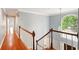 This home features an upstairs hallway with wood flooring and a large arched window at 1256 Spring Park Sw Dr, Atlanta, GA 30311