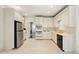Kitchen features white cabinetry, stainless steel appliances, and yellow accents creating a unique design at 1256 Spring Park Sw Dr, Atlanta, GA 30311