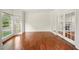 Bright living room with gleaming hardwood floors, large windows, and elegant French doors at 1256 Spring Park Sw Dr, Atlanta, GA 30311