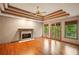 Spacious living room with hardwood floors, fireplace, ceiling fan, and french doors to the backyard at 1256 Spring Park Sw Dr, Atlanta, GA 30311