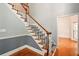 Elegant staircase with hardwood steps, white risers, and a wooden handrail, leading to the upper level at 1256 Spring Park Sw Dr, Atlanta, GA 30311