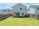 View of the house back, wooden fence, and backyard at 1436 Arbor Place Dr, Morrow, GA 30260