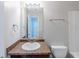 Bright bathroom featuring a single sink vanity with granite counter and a large mirror at 1436 Arbor Place Dr, Morrow, GA 30260