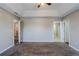 Large bedroom with tray ceiling, ceiling fan, neutral paint, and plush carpet at 1436 Arbor Place Dr, Morrow, GA 30260