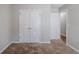 Neutral bedroom showcasing double door closet and a secondary door at 1436 Arbor Place Dr, Morrow, GA 30260