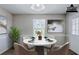 Staged dining room featuring a white marble table with seating for four and light gray paint at 1436 Arbor Place Dr, Morrow, GA 30260