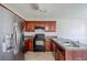 Functional kitchen with stainless steel refrigerator, black appliances, wood cabinets, and ample counter space at 1436 Arbor Place Dr, Morrow, GA 30260