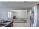 Open concept kitchen featuring views to the living room and stainless steel refrigerator at 1436 Arbor Place Dr, Morrow, GA 30260