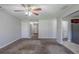 Spacious living room with neutral walls and carpet, ceiling fan, and view of front entrance at 1436 Arbor Place Dr, Morrow, GA 30260