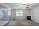 Cozy living room featuring fireplace and carpeted floors, open to adjacent room at 1436 Arbor Place Dr, Morrow, GA 30260