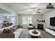 Comfortable living room features a fireplace, ceiling fan, and neutral tones with a cozy seating arrangement at 1436 Arbor Place Dr, Morrow, GA 30260