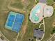 Overhead view of community pool and tennis court surrounded by green space at 2753 Trebek Ct, Mcdonough, GA 30253