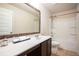 Bright bathroom featuring a large mirror, dark cabinets and a shower with a tub at 2753 Trebek Ct, Mcdonough, GA 30253