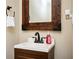 Rustic half bath with a wood-trimmed mirror and modern fixtures at 2753 Trebek Ct, Mcdonough, GA 30253