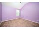 Purple-painted bedroom with carpet and a window at 2753 Trebek Ct, Mcdonough, GA 30253