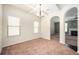 Formal dining room with modern lighting, neutral carpet, and large windows providing ample natural light at 2753 Trebek Ct, Mcdonough, GA 30253