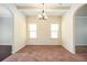 Formal dining room with modern lighting, neutral carpet, and large windows providing ample natural light at 2753 Trebek Ct, Mcdonough, GA 30253