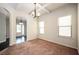 Formal dining room with modern lighting, neutral carpet, and large windows providing ample natural light at 2753 Trebek Ct, Mcdonough, GA 30253