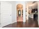 Inviting foyer with hardwood floors, arched doorways, and views into the dining room, living area, and kitchen at 2753 Trebek Ct, Mcdonough, GA 30253