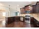 Well-equipped kitchen with granite counters, stainless steel appliances, and dark wood cabinetry at 2753 Trebek Ct, Mcdonough, GA 30253