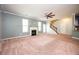 Spacious living room features a fireplace, large windows, and staircase at 2753 Trebek Ct, Mcdonough, GA 30253