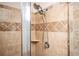 Close-up of shower featuring elegant tile, shower head and glass door at 2753 Trebek Ct, Mcdonough, GA 30253