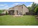 Wide view of the backyard featuring a nice patio, grill, and well-maintained lawn at 2955 Pleasant Valley Trl, Cumming, GA 30028