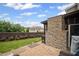 Backyard patio area featuring stone fireplace, exterior grill, lush lawn and garden at 2955 Pleasant Valley Trl, Cumming, GA 30028