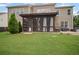 Exterior view of backyard showcasing a screen porch, patio, and lush green lawn at 2955 Pleasant Valley Trl, Cumming, GA 30028