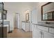 Bathroom featuring double vanities, granite countertops, tile flooring, and a soaking tub at 2955 Pleasant Valley Trl, Cumming, GA 30028