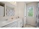Bright bathroom features double sinks, and a window that provides natural light and an airy feel at 2955 Pleasant Valley Trl, Cumming, GA 30028