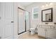 Bathroom with a glass-enclosed shower, modern lighting, a window and a vanity at 2955 Pleasant Valley Trl, Cumming, GA 30028
