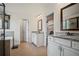 Bathroom featuring double vanities, granite countertops, tile flooring, and a soaking tub at 2955 Pleasant Valley Trl, Cumming, GA 30028