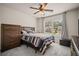 Cozy bedroom with soft carpet, ceiling fan, natural light, and a calming color scheme at 2955 Pleasant Valley Trl, Cumming, GA 30028